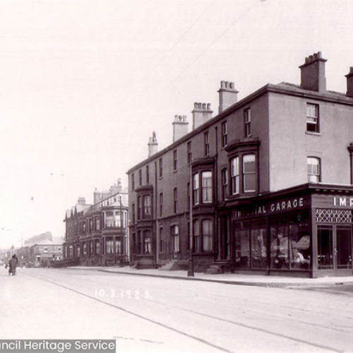 Street scene with houses and garage.