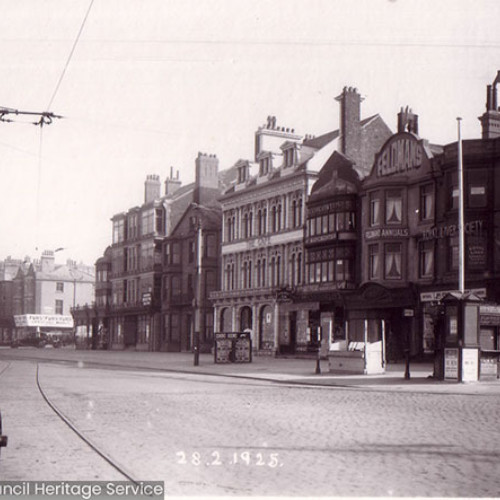 Street scene with arcade of shops and cafes.