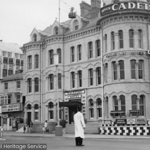 Palatine Hotel, Bonanza Amusements, Wilkins Jewellers and the corner of the Woolworths building with a small part of Blackpool Tower in the background.