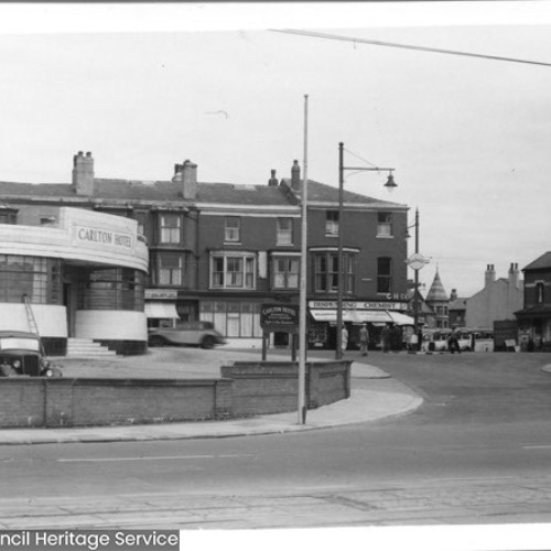 Street corner, with the Carlton Hotel partially shown.