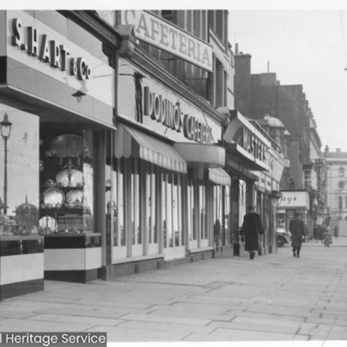 Shop fronts, including S. Hart & Co and a Cafeteria.