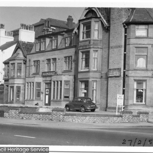 Street corner, with a hotel building on the corner advertised as Avondale.