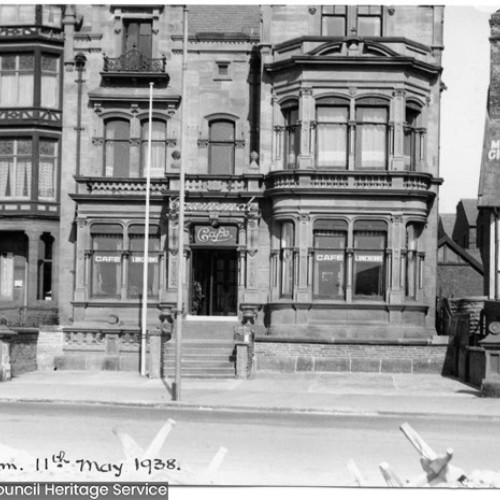 Exterior of three buildings, with the middle building advertised as Cramonde Cafe.