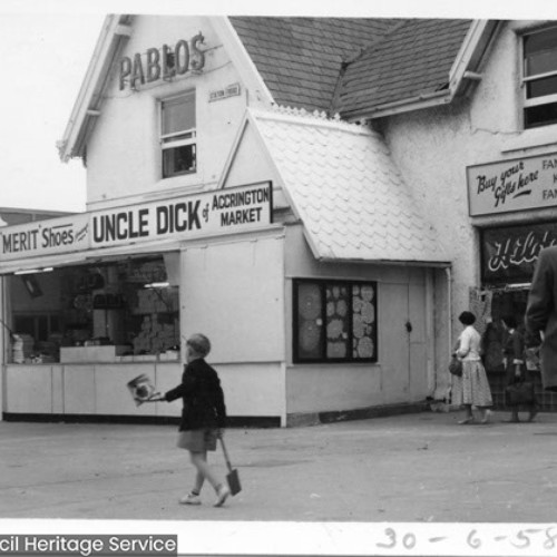 Businesses on street corner including Oyster Bar, Merit Shoes, Uncle Dick of Accrington Market and Pablos.