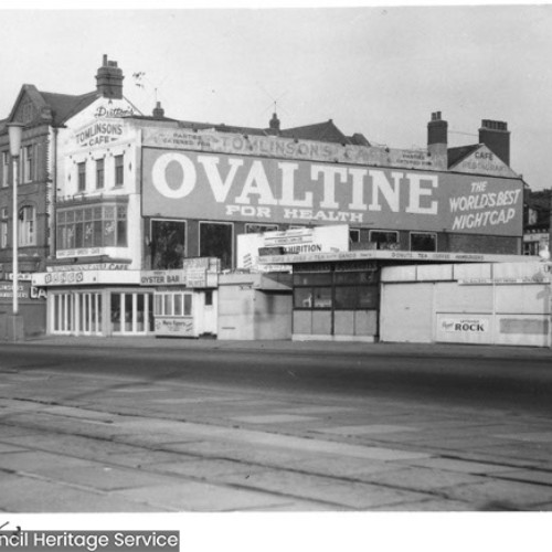 Exterior of Tomlinson's Cafe and a number of closed gift and refreshment stalls on the land next to the cafe.