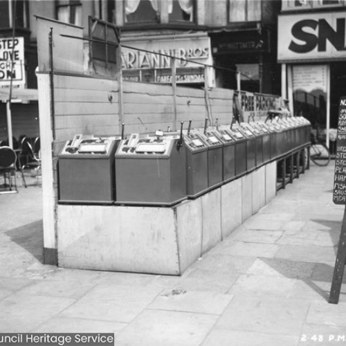 Machines on the forecourt of a Snack Bar and an A-Board with the food menu for Dinners.