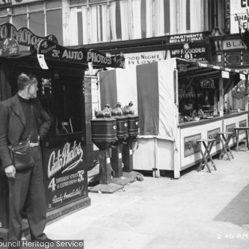 Auto Photos stall, with the male operator leaning on it and a refreshments stall.