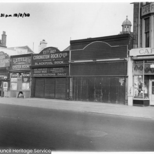 Row of buildings including Little's Central Oyster Rooms, Coronation Rock Co Ltd Makers of Blackpool Rock and a Cafe.