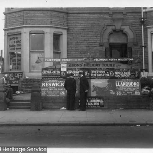 Booking office with advertising outside for coach tours including to Keswick and Llandudno.