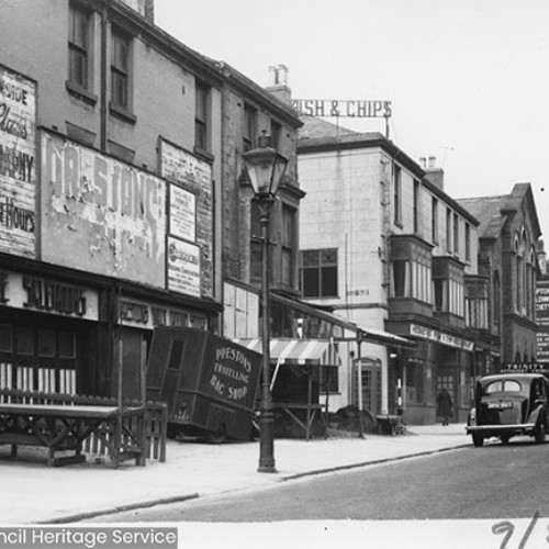 Shop fronts including a fish and chips shop.