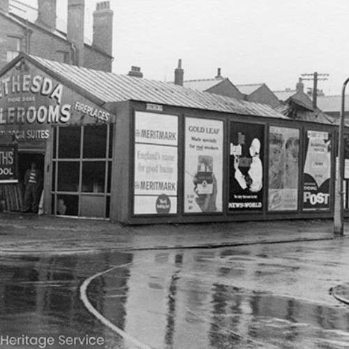Exterior of Bethesda Salerooms with a Heskeths Blackpool lorry parked outside. The side wall of the building is covered with advertising posters.