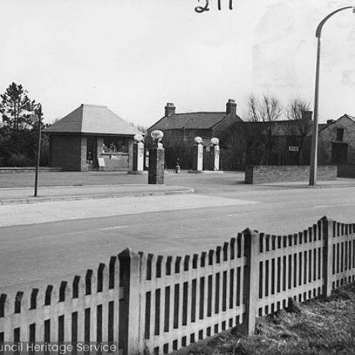 Service station and kiosk, with signs for Esso.