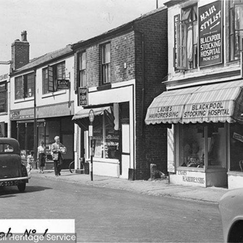Shop fronts including the Blackpool Stocking Hospital, Ladies Hairdressing and a Fish and Chips Cafe.