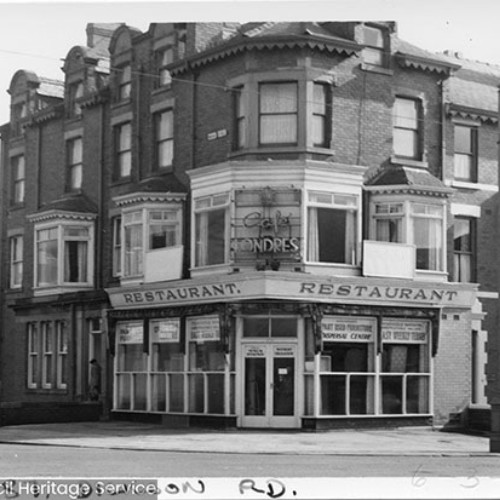 Street corner, with the main building on the corner being a Restaurant.