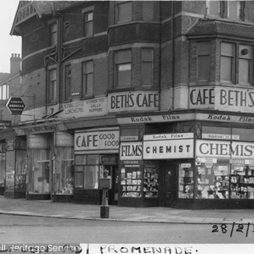 Shop fronts including Beth's Cafe and a chemist, which is also advertising Kodak Films.