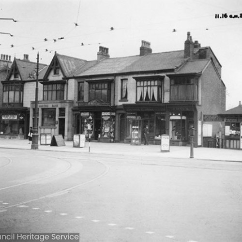 Row of shop fronts and a bank.