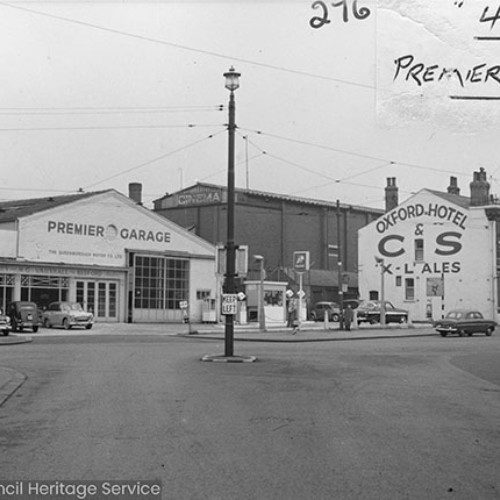 Road junction, with the Premier Garage to the left and the Oxford Hotel public house to the right, advertising C&S X-L Ales on their side wall.