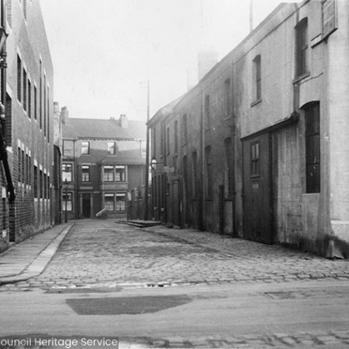 Buildings on both sides of a small cobbled street.