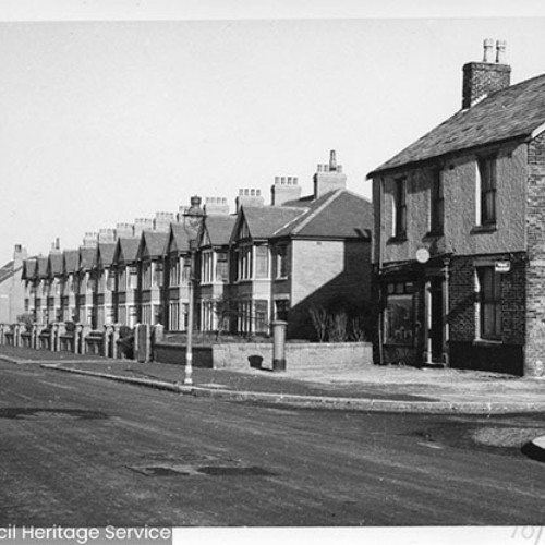 Buildings running alongside the right hand side of the road.