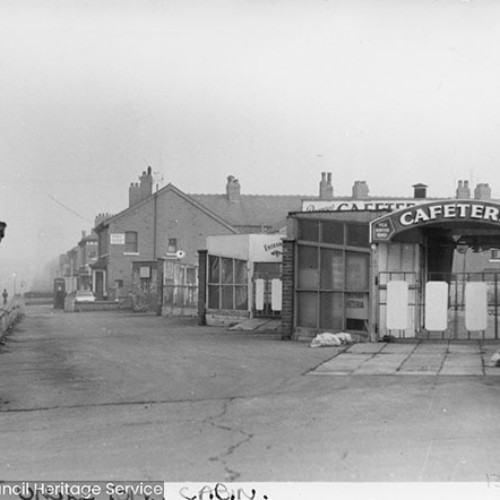 Exterior of Uncle Tom's Cabin Cafeteria, with houses behind.