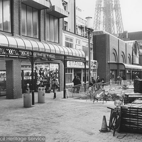 Road works in front of the shop fronts of Milletts and Stanleys.