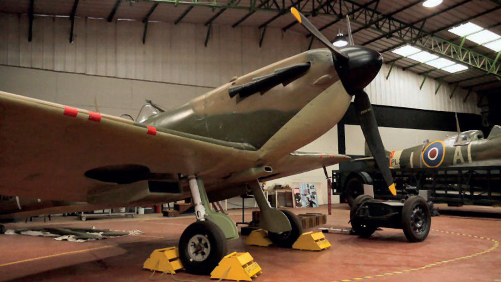 A Spitfire aeroplane inside a hangar.