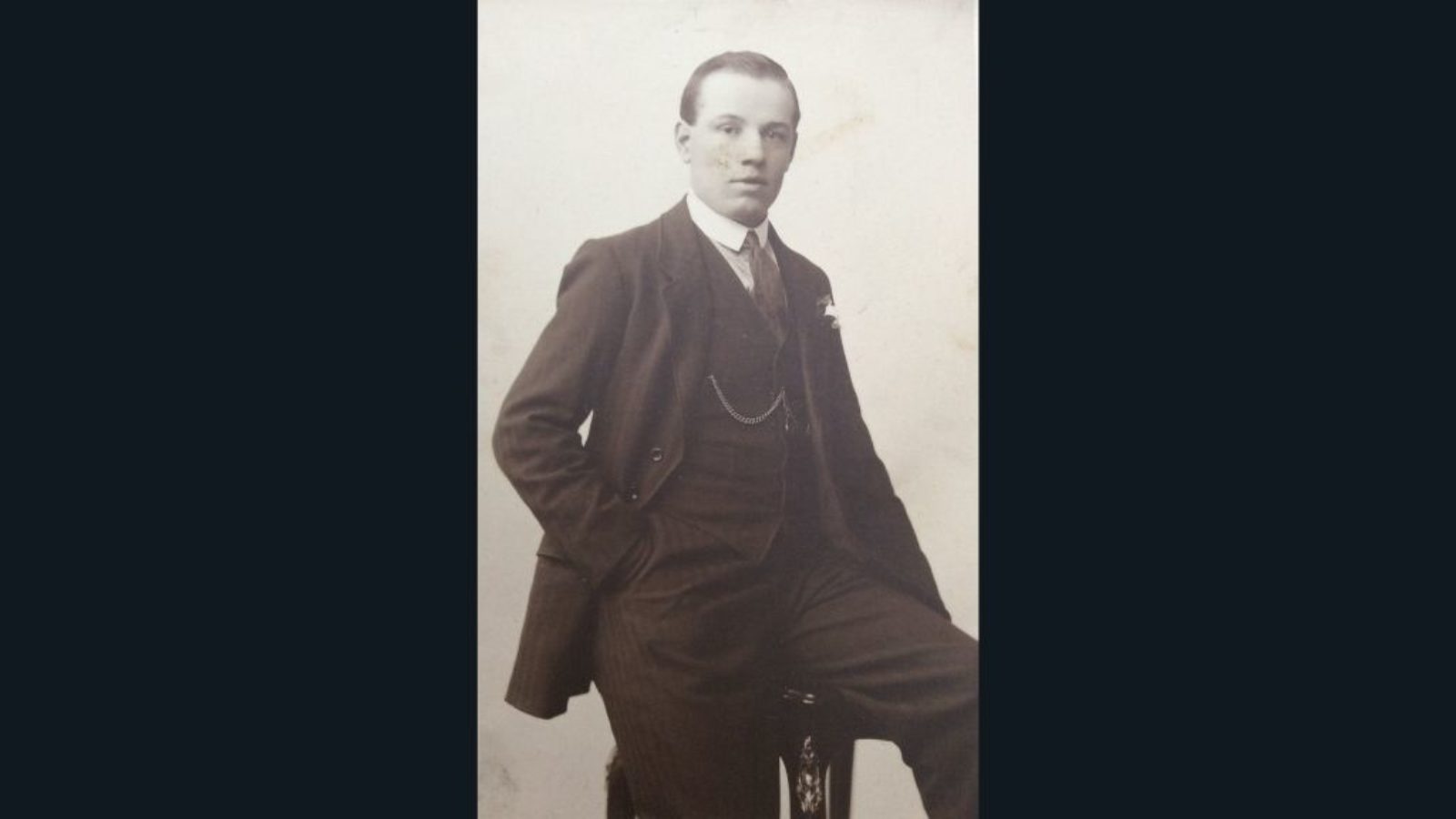 A portrait of a young man in a suit.