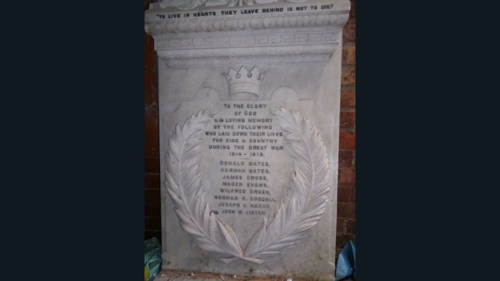 A close up of a carved marble memorial tablet.