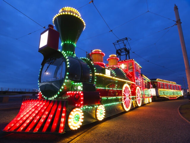 A photograph of the illuminations tram which is brightly lit up to look like a train