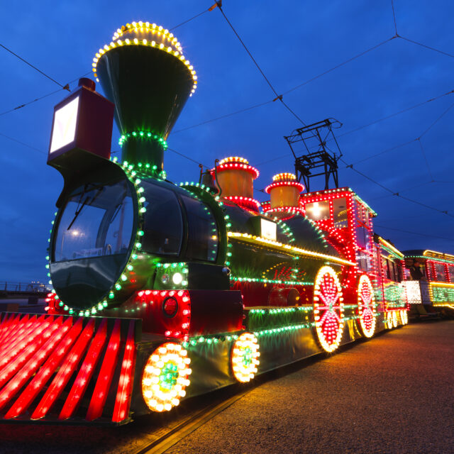 A photograph of the illuminations tram which is brightly lit up to look like a train