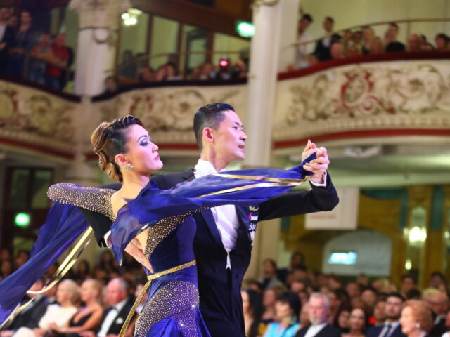Ballroom dancers performing in front of a crowd