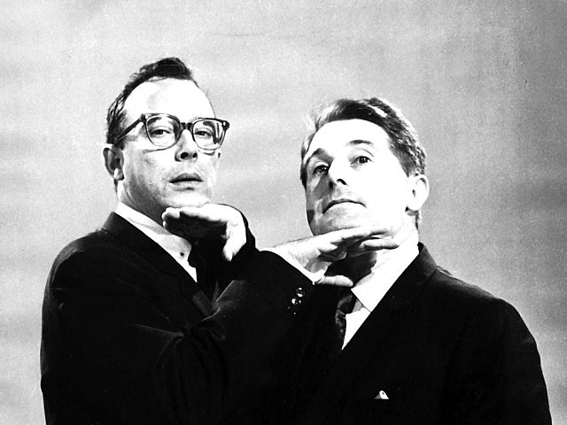 A black and white photo of Morecombe and Wise doing a silly pose