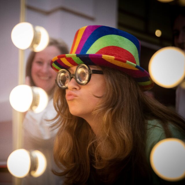 Girl wearing hat and glasses