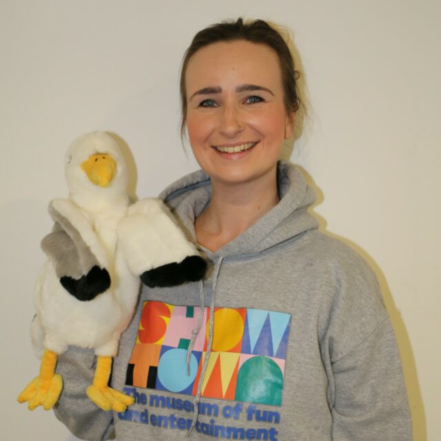 Head and shoulders shot of Beth holding seagull puppet