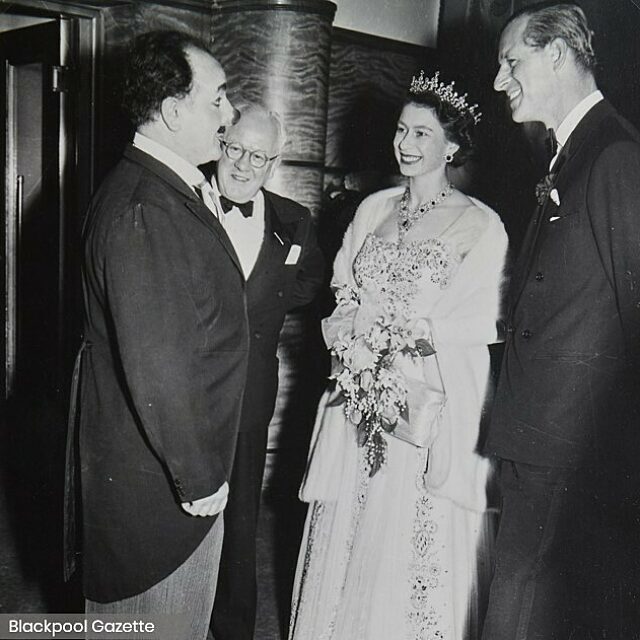 Black and white picture of The Queen and the Duke of Edinburgh meeting clown, Charlie Cairoli at Blackpool Opera House in 1955.