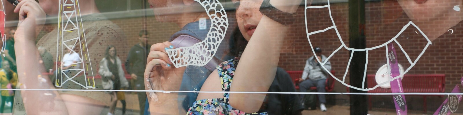 Young People's Steering Group doing window art at the Activity Hub