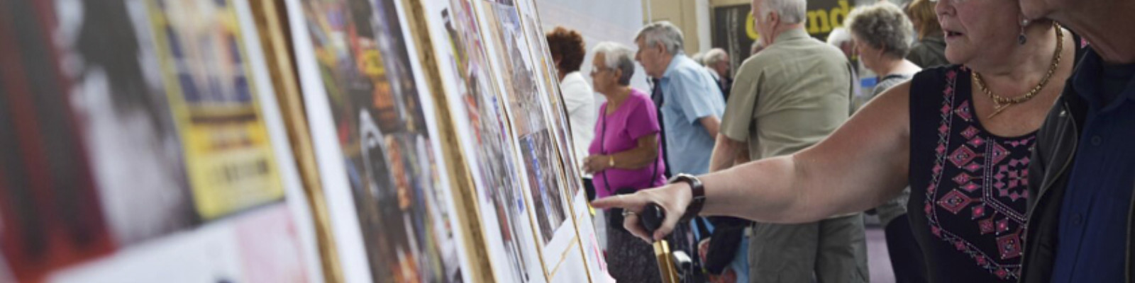 Couple looking and pointing at a display of images.