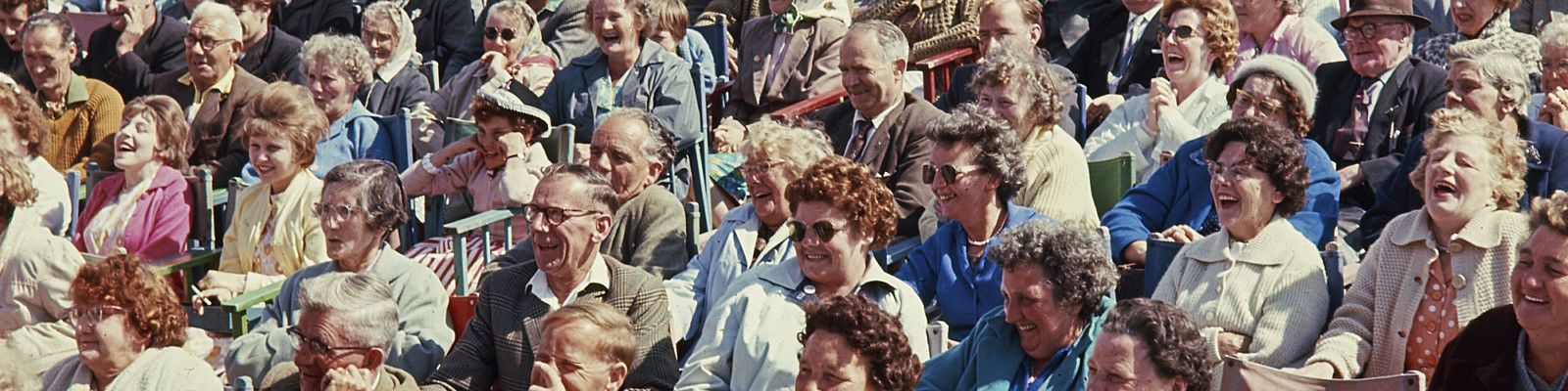 Crowd of people sat packed together on North Pier