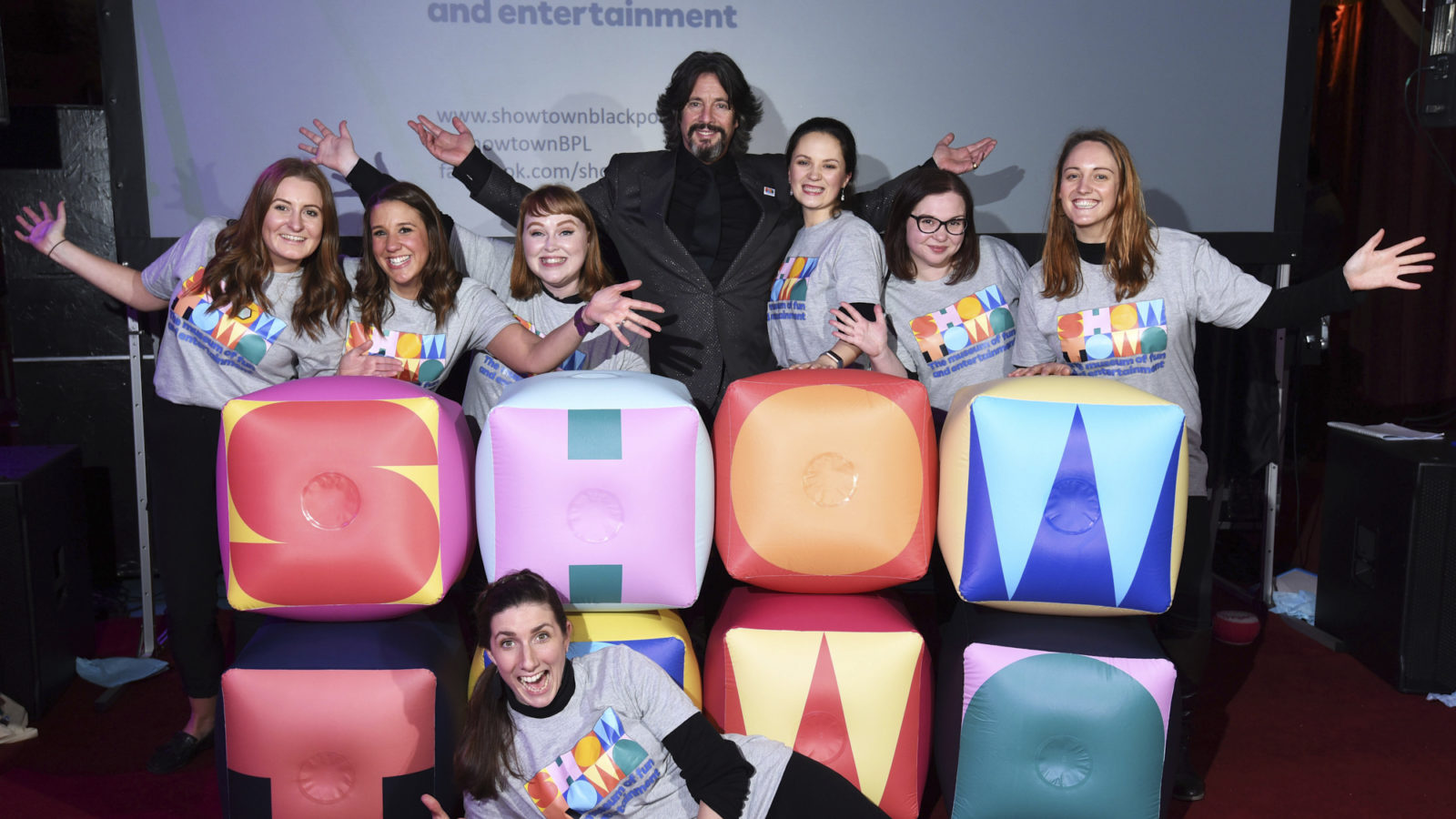 Showtown team and Laurence Lewellyn Bowen posing behind a large Showtown logo.