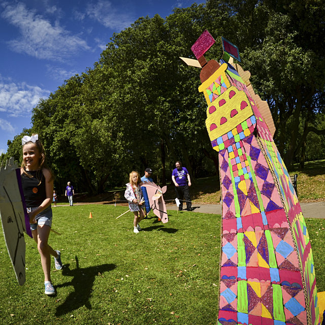 Children playing next to a colourful crafted Blackpool Tower, on a sunny day