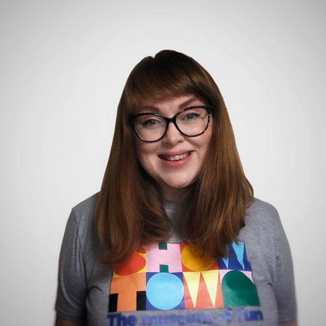 Becky smiling, wearing a Showtown t-shirt.