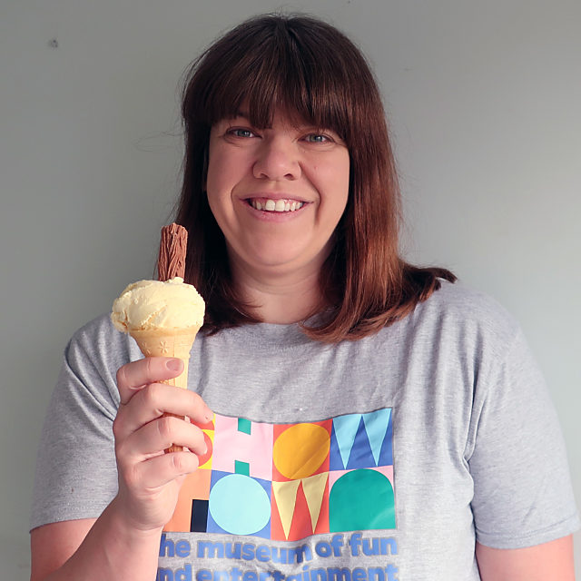 Caroline smiling in a Showtown t-shirt holding an ice- cream