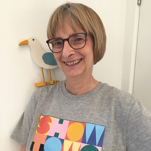 Heather with a Showtown t-shirt and a wooden seagull perched on her shoulder