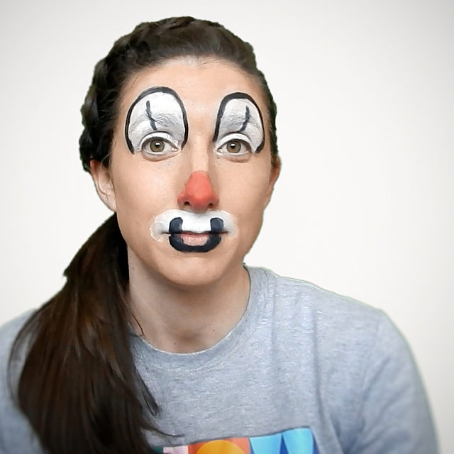 Jill wearing clown make up in a Showtown t-shirt.