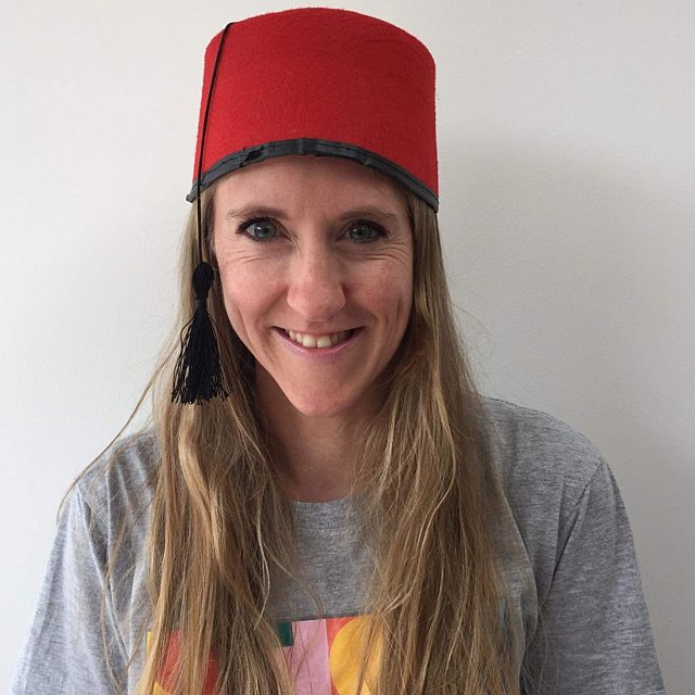 Kerry wearing a red fez and a Showtown t-shirt