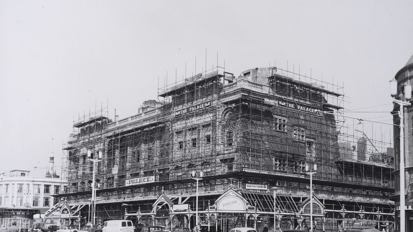 A old black and white photograph of a the Palace, covered in scaffolding
