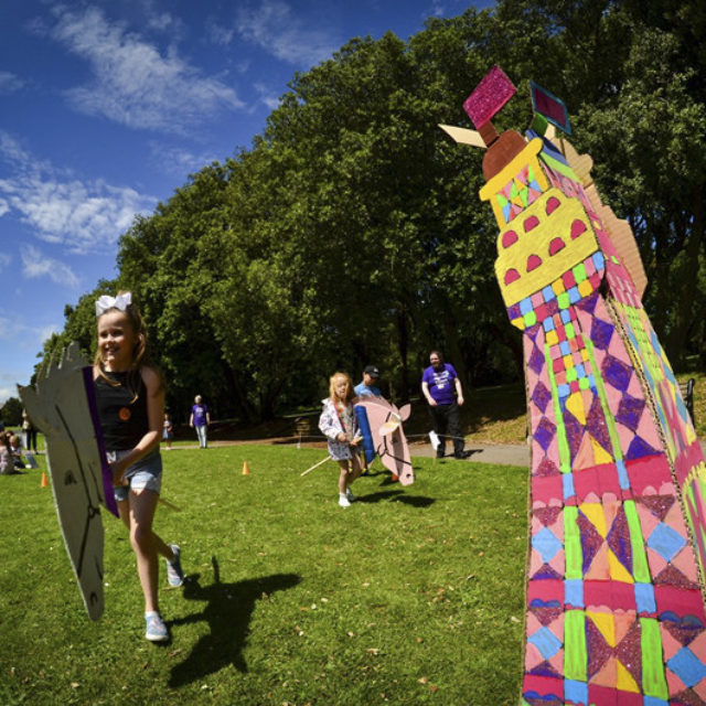 Children playing next to a crafted Blackpool tower on a sunny day