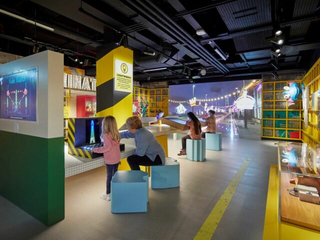 Illuminations gallery at Showtown.  Family sat at interactive tables creating light show.