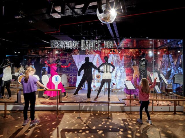 Dance gallery at Showtown.  Two girls dancing and playing with score paddles with dance costumes on models